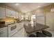 Bright kitchen featuring a breakfast bar with seating, white cabinets, modern appliances, and granite countertops at 12024 Stone Crossing Cir, Tampa, FL 33635