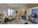Bright living room featuring a large window, neutral tones, and comfortable seating arrangements at 12024 Stone Crossing Cir, Tampa, FL 33635