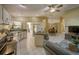Inviting open-concept living space features a cozy seating area, a modern kitchen, and a dining area with lots of natural light at 12024 Stone Crossing Cir, Tampa, FL 33635
