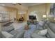 Open-concept living area with a large TV, comfortable seating, and an adjacent dining space for versatile living at 12024 Stone Crossing Cir, Tampa, FL 33635