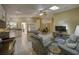 Inviting open-concept living space features a cozy seating area, a modern kitchen, and a dining area with lots of natural light at 12024 Stone Crossing Cir, Tampa, FL 33635