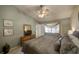 Cozy bedroom with a ceiling fan, window, and television for ultimate comfort and relaxation at 12024 Stone Crossing Cir, Tampa, FL 33635