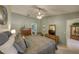 Relaxing bedroom showcasing a ceiling fan, ensuite access, and ample natural light at 12024 Stone Crossing Cir, Tampa, FL 33635