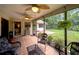 Relaxing screened porch with tiled floor and ceiling fans overlooking the backyard and outdoor space at 12024 Stone Crossing Cir, Tampa, FL 33635