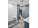 View of an updated bathroom with a tiled walk-in shower, storage shelves and a double sink vanity at 1226 Serpentine S Dr, St Petersburg, FL 33705