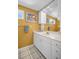 Bright bathroom features a large mirror and vanity with white cabinets and cream walls at 1226 Serpentine S Dr, St Petersburg, FL 33705