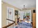 Upstairs hallway with hardwood floors leading to a bedroom and office at 1226 Serpentine S Dr, St Petersburg, FL 33705