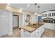 Well-lit kitchen with a large island, seating, custom cabinetry, and stainless steel appliances at 1226 Serpentine S Dr, St Petersburg, FL 33705