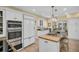 Elegant kitchen featuring stainless steel appliances, a large island, and classic white cabinetry at 1226 Serpentine S Dr, St Petersburg, FL 33705