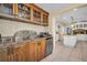 Gourmet kitchen with wood cabinetry, granite countertops, and stainless steel appliances, perfect for entertaining at 1226 Serpentine S Dr, St Petersburg, FL 33705