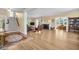 Spacious living room with fireplace, staircase, and refinished wood flooring at 1226 Serpentine S Dr, St Petersburg, FL 33705
