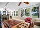 Bright living room with refinished wood floors, vintage seating, and natural lighting at 1226 Serpentine S Dr, St Petersburg, FL 33705