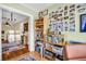 This office space leads to the hallway and has wood floors, a desk and decorative photos at 1226 Serpentine S Dr, St Petersburg, FL 33705