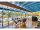 Outdoor patio features wood floors, comfortable dining for six, and views of the pool at 1226 Serpentine S Dr, St Petersburg, FL 33705