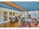 The outdoor covered patio features wicker seating and outdoor dining on wooden floors at 1226 Serpentine S Dr, St Petersburg, FL 33705