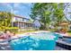 Backyard pool with lounge chairs and well-maintained landscaping on a sunny day at 1226 Serpentine S Dr, St Petersburg, FL 33705