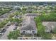 Wide aerial perspective showing the community's layout, parking, and mature tree coverage at 12937 Trade Port Pl, Riverview, FL 33579