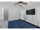 Bedroom with light blue walls, wood-look flooring and access to bathroom at 12937 Trade Port Pl, Riverview, FL 33579