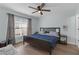Bedroom featuring wood-look floors, large window, and ceiling fan at 12937 Trade Port Pl, Riverview, FL 33579