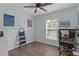 Bedroom with light blue walls, wood-look flooring, and a ceiling fan at 12937 Trade Port Pl, Riverview, FL 33579
