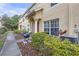 Inviting townhome exterior showcasing well-kept landscaping, a covered entryway, and a charming facade at 12937 Trade Port Pl, Riverview, FL 33579