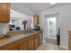 Kitchen with stainless steel sink, overhead cabinets, and view into living area at 12937 Trade Port Pl, Riverview, FL 33579