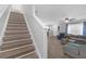 Inviting living room with light wood flooring and staircase access to the next level at 12937 Trade Port Pl, Riverview, FL 33579