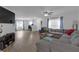Open-concept living area with hardwood floors, neutral tones, and abundant natural light at 12937 Trade Port Pl, Riverview, FL 33579