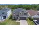 Aerial view of a two-story home with a lush green lawn and a two-car garage in a suburban neighborhood at 13802 Kinsale St, Riverview, FL 33579
