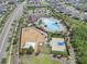 An aerial view of a community park with a playground, pool, and basketball court amidst a residential area at 13802 Kinsale St, Riverview, FL 33579