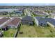 Aerial view of a home showcasing its large backyard, neighborhood streets, and community lake at 13802 Kinsale St, Riverview, FL 33579