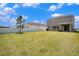 Spacious backyard with a well-maintained lawn, white fence, and covered patio, great for outdoor entertaining at 13802 Kinsale St, Riverview, FL 33579
