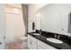 Elegant bathroom with double sinks, a black countertop, and a tub with curtain at 13802 Kinsale St, Riverview, FL 33579