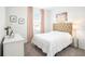 Cozy bedroom with a tufted headboard, plush carpet, and soft natural light at 13802 Kinsale St, Riverview, FL 33579