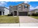 Charming two-story home with a well-manicured lawn, two-car garage, and a welcoming front porch at 13802 Kinsale St, Riverview, FL 33579