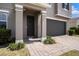 Close-up of home's entry featuring brick-paved walkway, two-car garage, manicured bushes and trimmed lawn at 13802 Kinsale St, Riverview, FL 33579