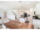 Open floor plan featuring dining and kitchen space, white cabinets, black appliances, and stylish pendant lighting at 13802 Kinsale St, Riverview, FL 33579