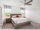 Bright main bedroom features neutral walls, plush carpet, ceiling fan, and modern bedside lamps at 13802 Kinsale St, Riverview, FL 33579