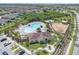 An aerial view of the community pool, clubhouse, playground, and parking area in a residential neighborhood at 13802 Kinsale St, Riverview, FL 33579