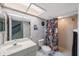 Eclectic bathroom with unique wallpaper, glass enclosed shower and vinyl record album art at 14649 Seminole Trl # 5, Seminole, FL 33776