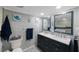 Charming bathroom with double vanity, decorative tile flooring, and beach themed decorations at 14649 Seminole Trl # 5, Seminole, FL 33776