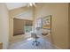 Bedroom with vaulted ceiling, window, work desk, and custom window shades at 14649 Seminole Trl # 5, Seminole, FL 33776