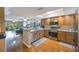Open Kitchen boasts stainless appliances, wood cabinets, granite countertops, and seamless access to living areas at 14649 Seminole Trl # 5, Seminole, FL 33776