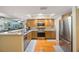 Bright kitchen features wood cabinets, stainless steel appliances, tile floors, and an abundance of natural light at 14649 Seminole Trl # 5, Seminole, FL 33776