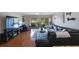Comfortable living room featuring hardwood floors, a ceiling fan, and a sliding glass door leading to an outdoor balcony at 14649 Seminole Trl # 5, Seminole, FL 33776