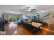 Open concept living space with hardwood floors, ceiling fan, dining area, and staircase leading to the second floor at 14649 Seminole Trl # 5, Seminole, FL 33776