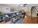Open concept living space with hardwood floors, ceiling fan, and staircase leading to the second floor at 14649 Seminole Trl # 5, Seminole, FL 33776