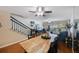 Open-concept living room featuring a wood dining table, modern ceiling fans and a view of a balcony at 14649 Seminole Trl # 5, Seminole, FL 33776