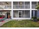 Rear enclosed patio, leads to fenced in back yard, outdoor bench and lush landscaping at 14649 Seminole Trl # 5, Seminole, FL 33776