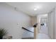 Stairway with carpeted steps, black handrail, neutral walls, and tiled landing area at 14649 Seminole Trl # 5, Seminole, FL 33776